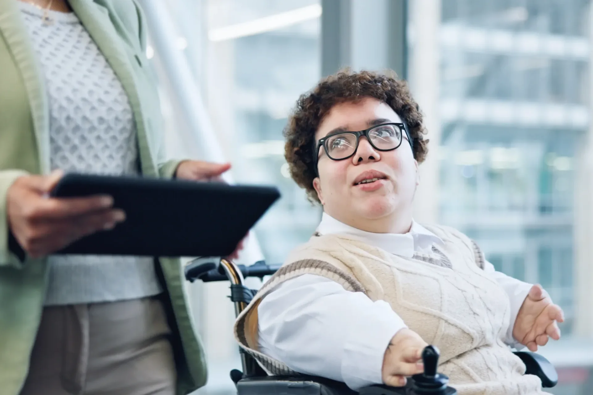 Disabled woman in wheelchair at workspace