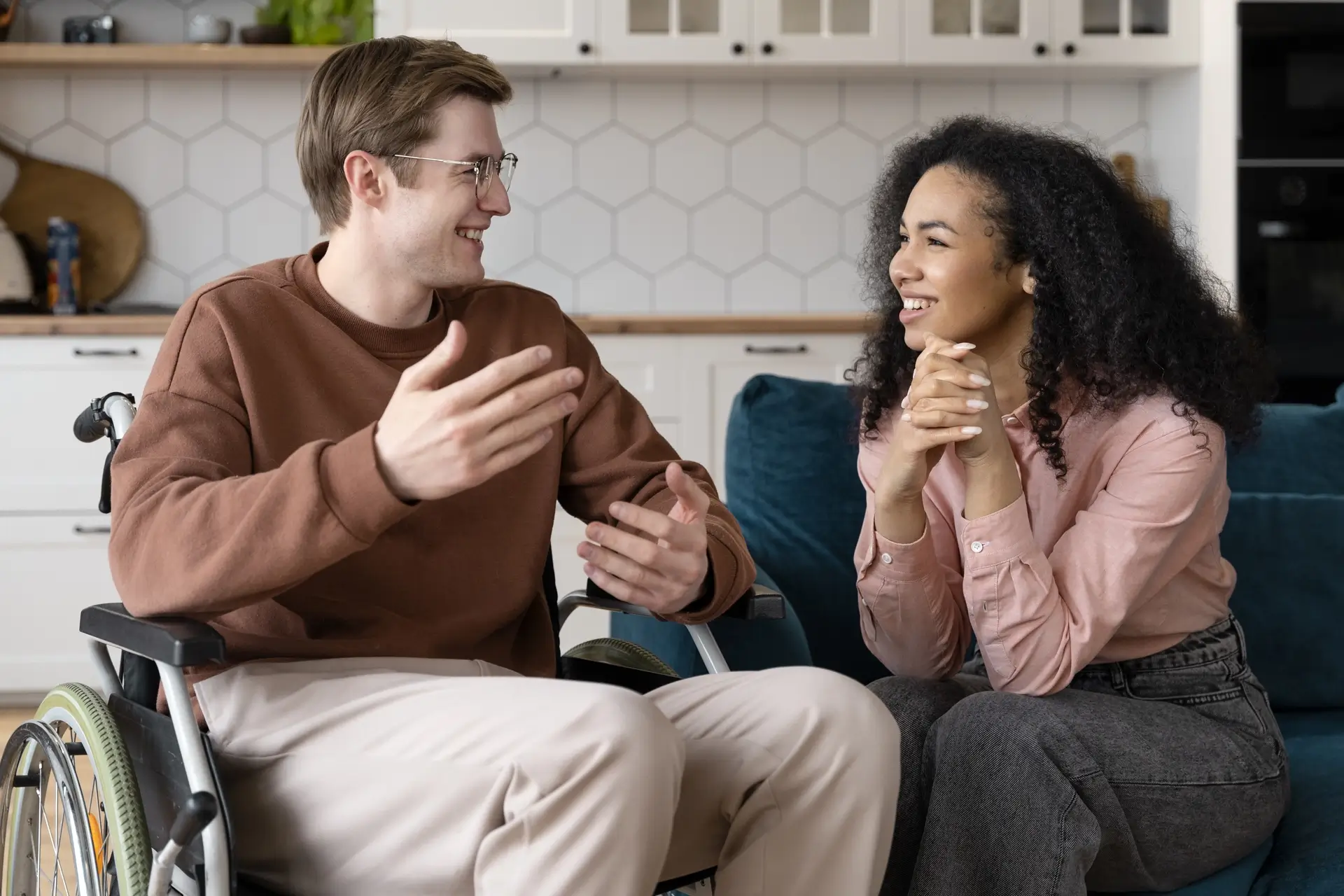 NDIS participant and support worker smiling while discussing