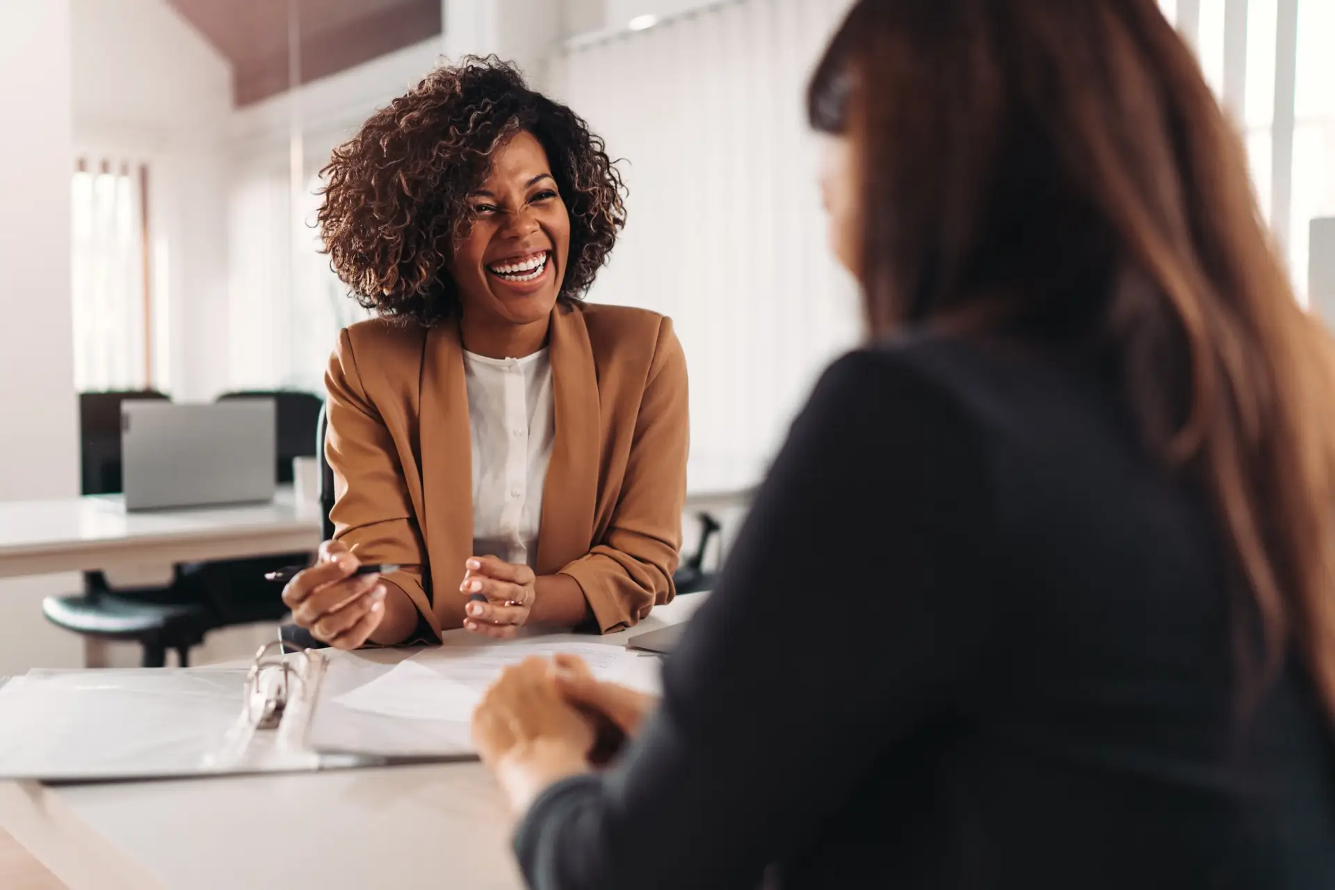 Two women discussing and laughing