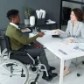 Man in wheelchair with a lady in the office